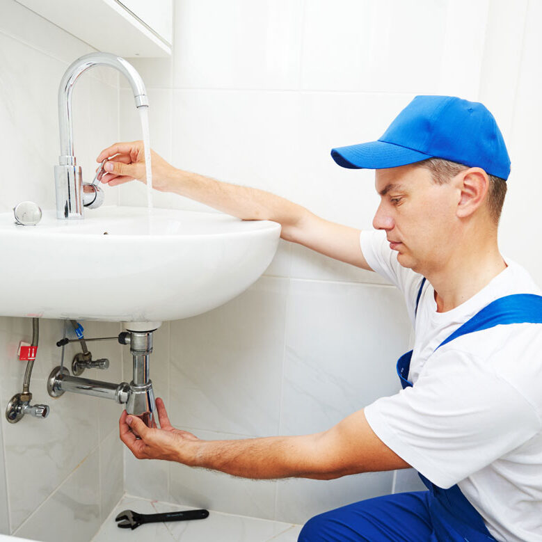 Man-inspecting-sink-for-leaks